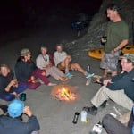 Tsunami Rangers and friends gather round the fire to enjoy cocktails on retreat
