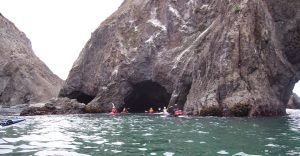 The team prepares to enter a cave